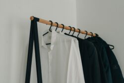 white dress shirt hanged on black clothes hanger